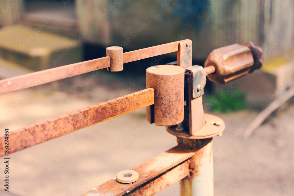 Ancient platform scales; wood and iron weighing machine. Selective focus. Tinted photograph.