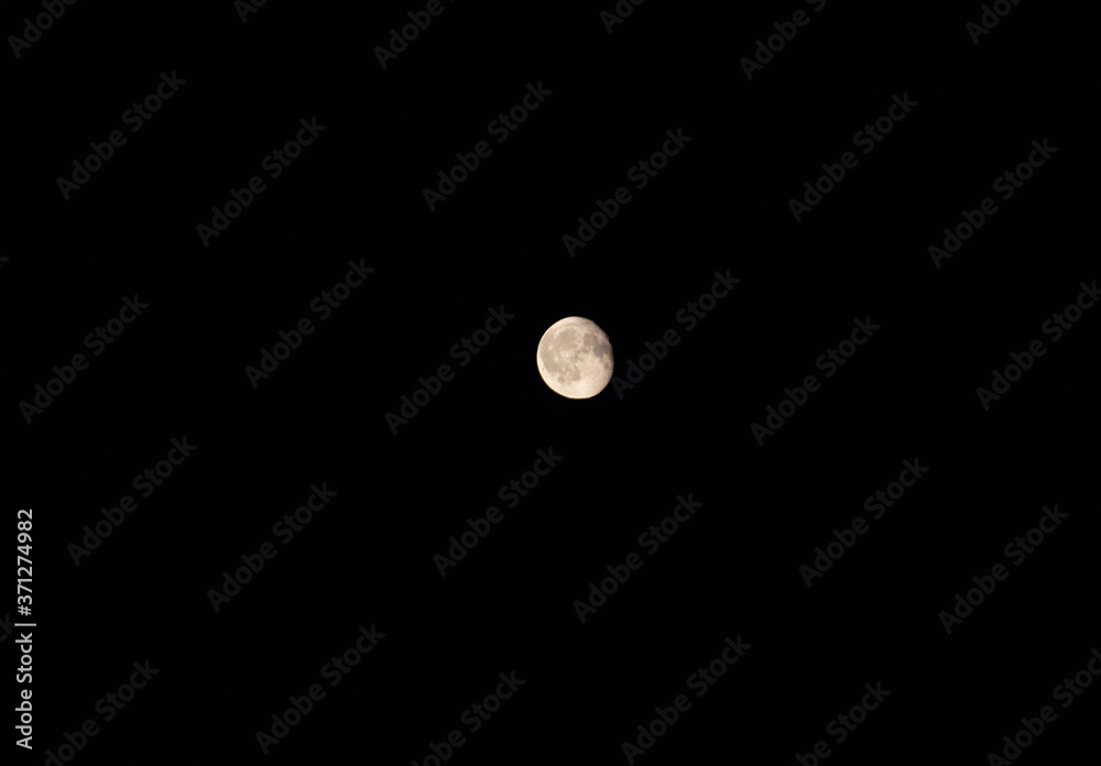 Full moon over dark black sky at night Full moon over dark black sky at night