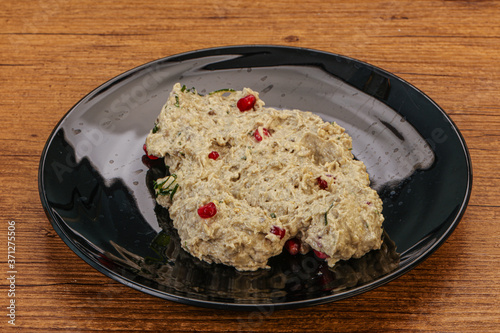 Vagan dietary cusine - mutabal with granet seeds photo