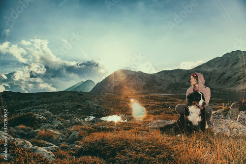 The girl travels in the mountains with her dog © Radarani