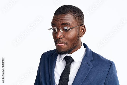 portrait of a handsome man of African appearance in a suit on a light background cropped view close-up model