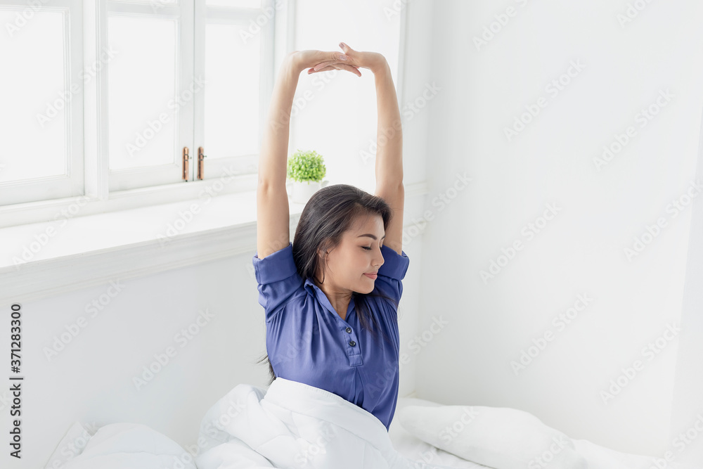 Happy young woman waking up on bed and was waking up In Morning. She felt very refreshed. Happy young woman waking up on bed and was waking up In Morning. She felt very refreshed.
