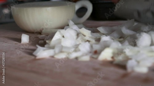 A woman's hands splitting vegetables on a wooden board in the kitchen