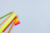 Bright colorful school supplies on a light blue background. Place for text. View from above. Education concept.