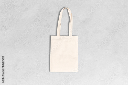 Shopping canvas or cotton bag on grey concrete background. Mock-up for branding. 
