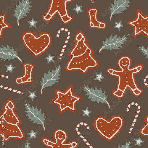 Christmas seamless pattern with candy canes, gingerbreads and leafs. Repetitive vector pattern design.