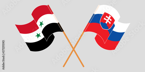 Crossed and waving flags of Syria and Slovakia
