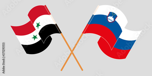 Crossed and waving flags of Syria and Slovenia