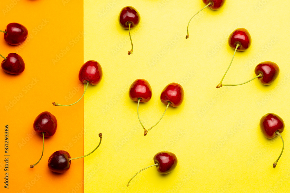 Cherry berries on a yellow and orange background top view.Background with a cherry on a sprig, flat lay.
Cherry berries on a yellow and orange background top view.Background with a cherry on a sprig, flat lay.
