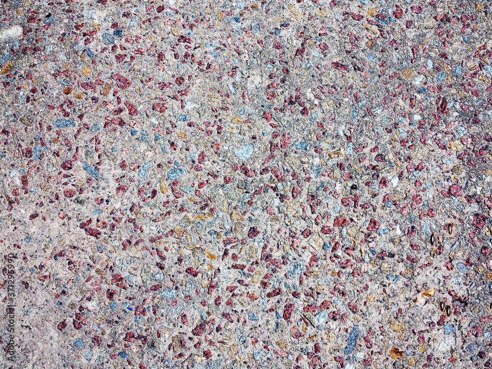 textured background concrete surfaces interspersed with small stones