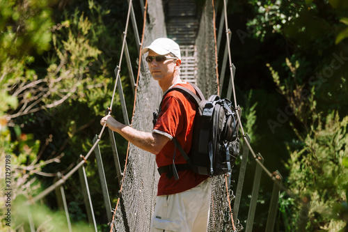 Man on swing bridge in New Zealand
