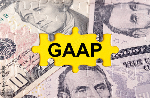 Puzzle with the image of dollars in the center of the inscription -GAAP