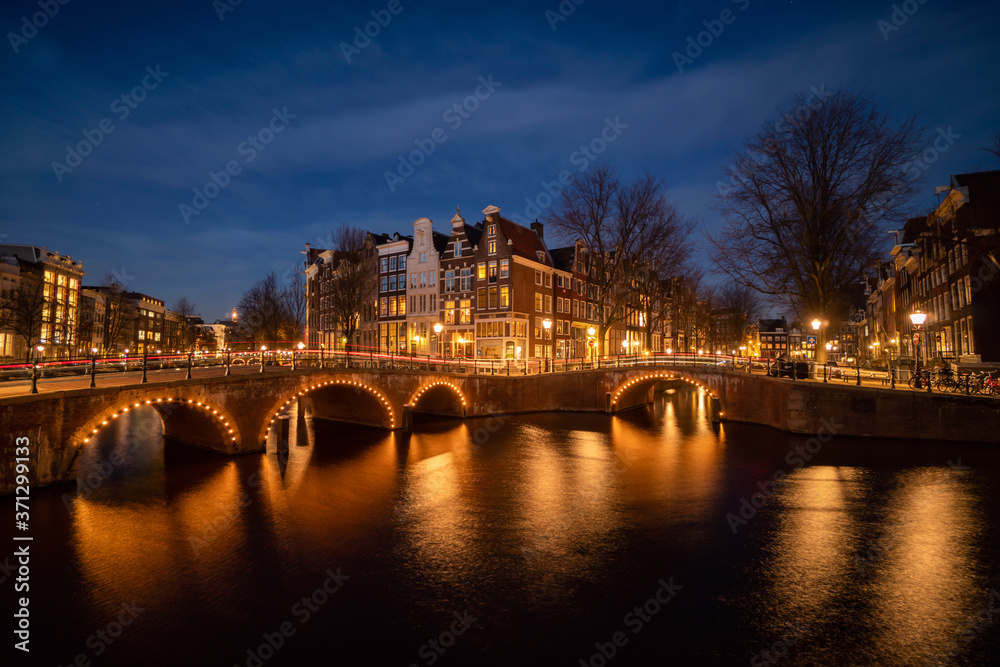 Naklejka premium Amsterdam canal at twilight in winter, Amsterdam is the capital and most populous city in Netherlands.