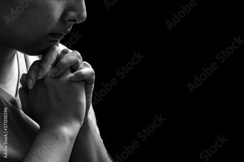 Women praying to God and spending time in God’s word on black