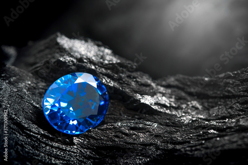 blue sapphir on black coal background photo