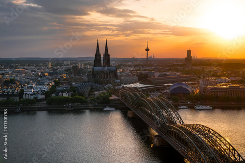 panorama view of Cologne Cathedral and Hohenzollern Bridge at sunset, Germany