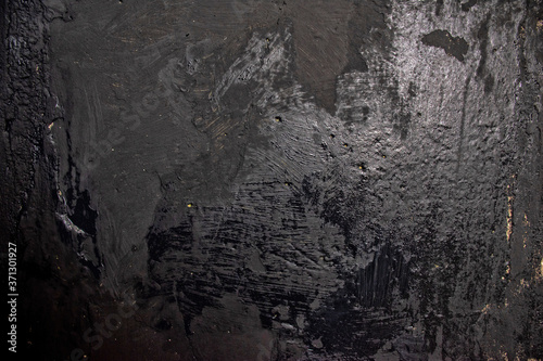 Wet black paint on concrete wall (grunge effect), abstract image