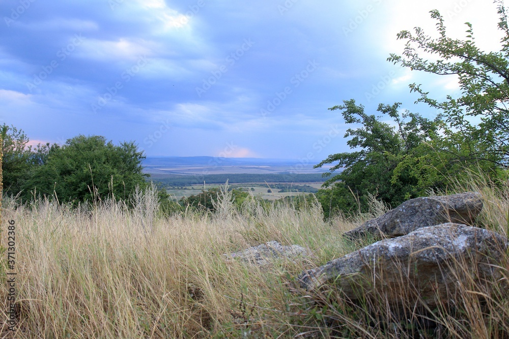 View of the plain from a height in the vicinity of the village of Avren (Bulgaria) at sunset View of the plain from a height in the vicinity of the village of Avren (Bulgaria) at sunset