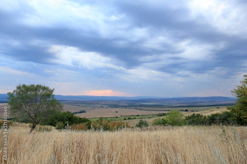 View of the plain from a height in the vicinity of the village of Avren (Bulgaria) at sunset