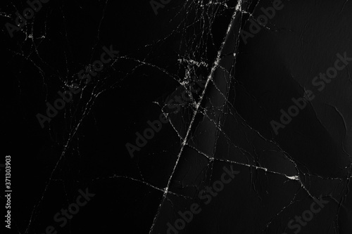 Crumpled and worn surface of dark black paper