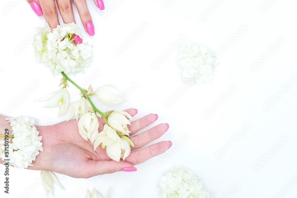 Fashion art portrait woman in summer dress and flowers in her hand with a bright contrasting makeup. Creative beauty photo girls sitting at table on a contrasting pink background with colored shadows Fashion art portrait woman in summer dress and flowers in her hand with a bright contrasting makeup. Creative beauty photo girls sitting at table on a contrasting pink background with colored shadows