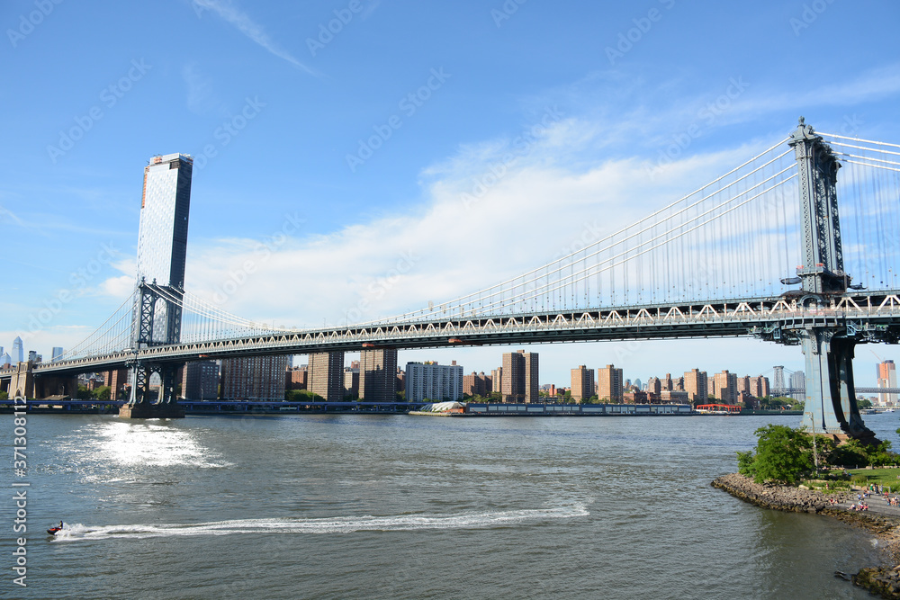 Fototapeta premium Brooklyn, USA - June 09, 2019: Relaxing place Brooklyn Bridge Park with beautiful panoramic view to Manhattan