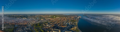 Fotografie Panoramic aerial view of Aalborg city and Aalborg port in the early morning with