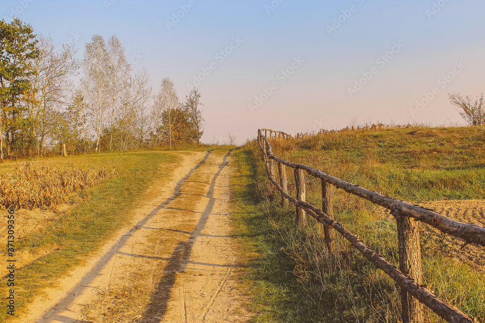 path in the field. wooden rustic fence