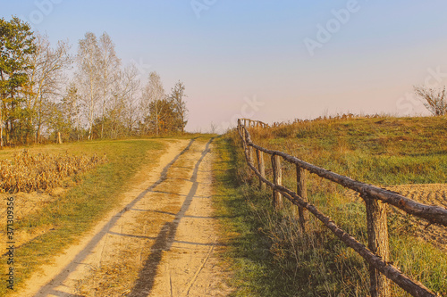 path in the field. wooden rustic fence