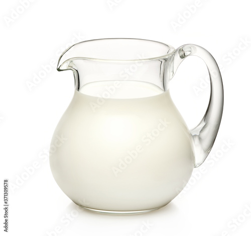 Glass jug of milk isolated on white background