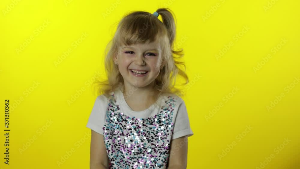 Happy child pointing finger at camera and laughing out loud with tears, making fun of funny joke Happy child pointing finger at camera and laughing out loud with tears, making fun of funny joke