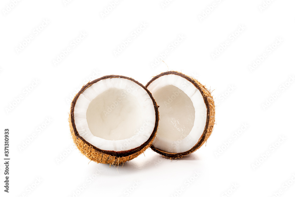 Coconut on a black background. Chopped coconut. Several parts. Stone surface. Fresh coconut. White pulp. Coconut on a black background. Chopped coconut. Several parts. Stone surface. Fresh coconut. White pulp.