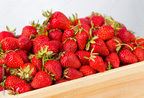 Ripe strawberries ready for eating in wooden boxes. Red ripe strawberries closeup. Selective focus. You can use as the background for any of Your project.