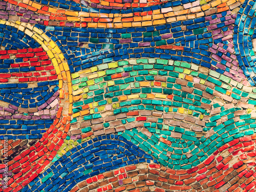Detail of beautiful old collapsing abstract ceramic mosaic adorned building. Venetian mosaic as decorative background. Selective focus. Abstract Pattern. Abstract mosaic colored ceramic stones