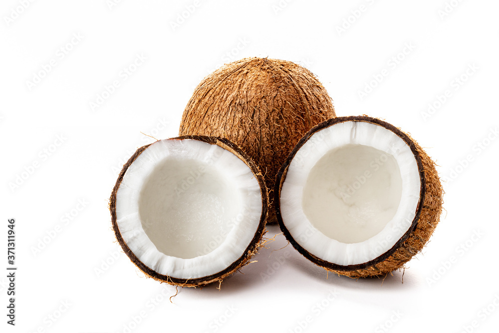 Coconut on a black background. Chopped coconut. Several parts. Stone surface. Fresh coconut. White pulp. Coconut on a black background. Chopped coconut. Several parts. Stone surface. Fresh coconut. White pulp.