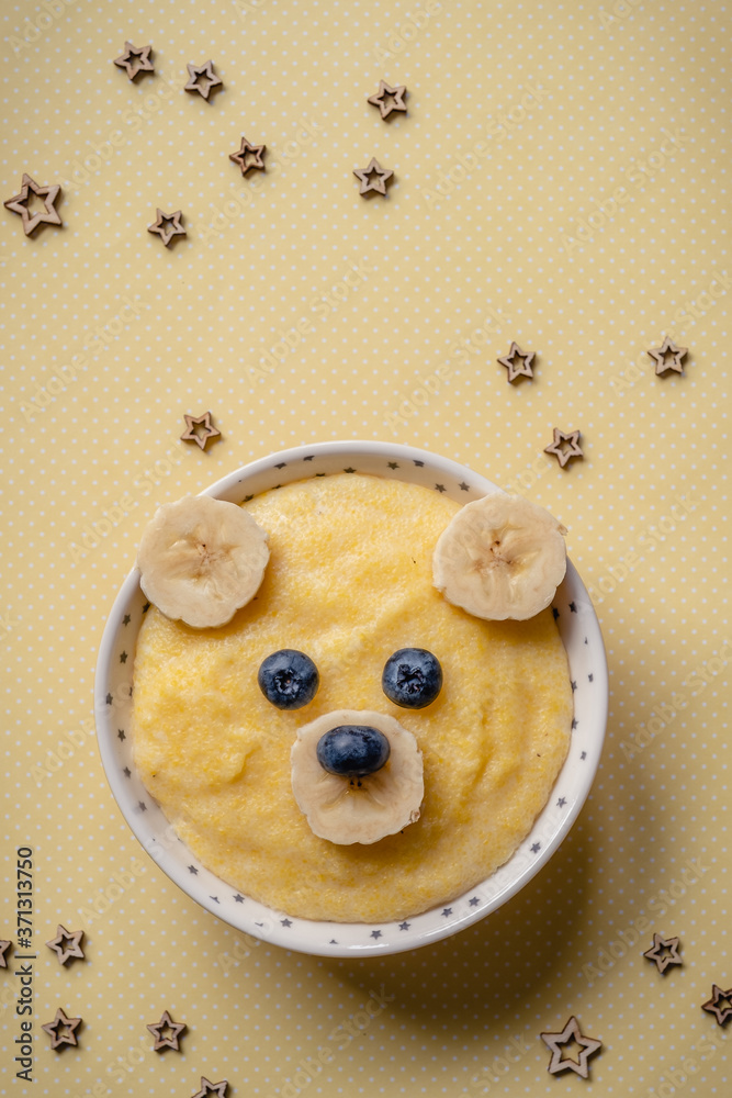 Kids breakfast, porridge with fruits and berries, face bears Kids breakfast, porridge with fruits and berries, face bears