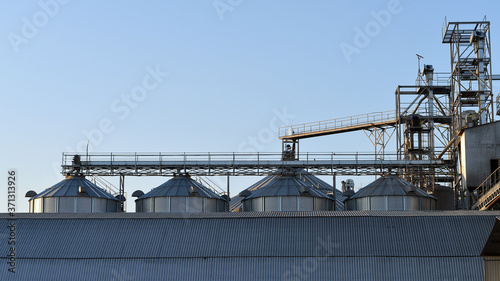 agribusiness  agricultural  agriculture  architecture  bin  blue  building  business  cereal  clouds  container  corn  country  elevator  farm  farming  field  food  grain  granary  harvest  industria