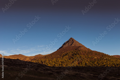 Sunset colors over the top of a volcano-shaped mountain  Col Quaterna  Dolomites  Veneto  Italy. Panorama that inspires peace  tranquility and meditation