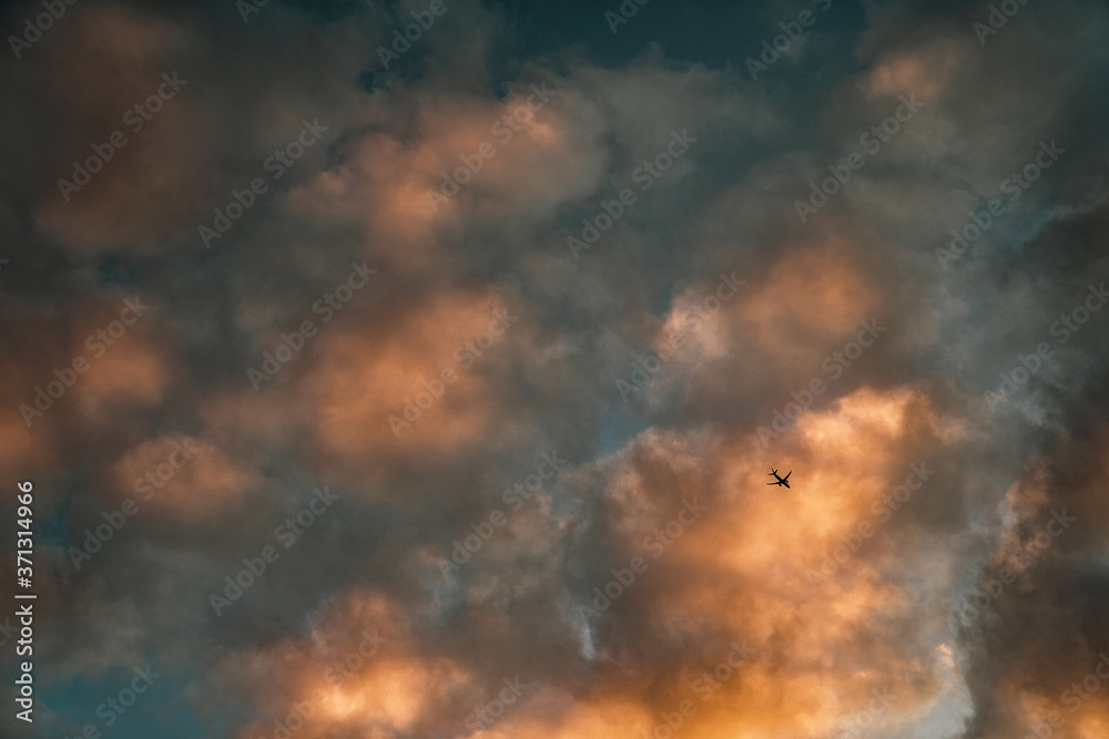 Plane in sunset clouds 2