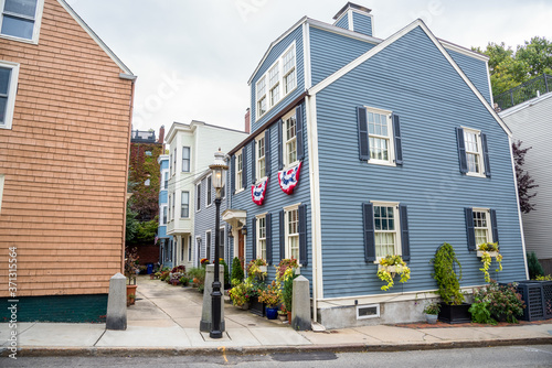 Colourful traditional American wooden houses along a narrow alley on a cloudy autumn day photo