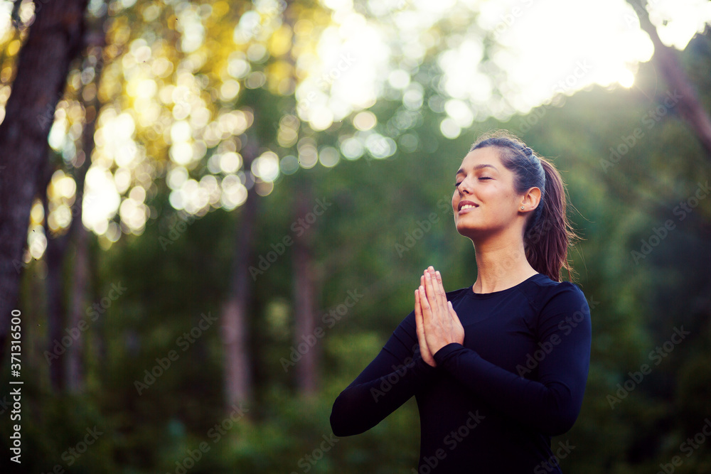 Portrait of pretty woman practicing yoga in a forest Portrait of pretty woman practicing yoga in a forest