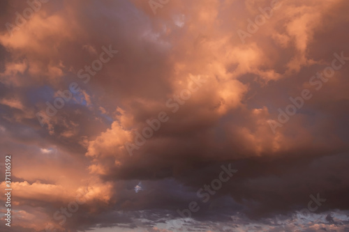 Heaven. Epic Dramatic yellow orange sunset storm cumulus clouds in sunlight