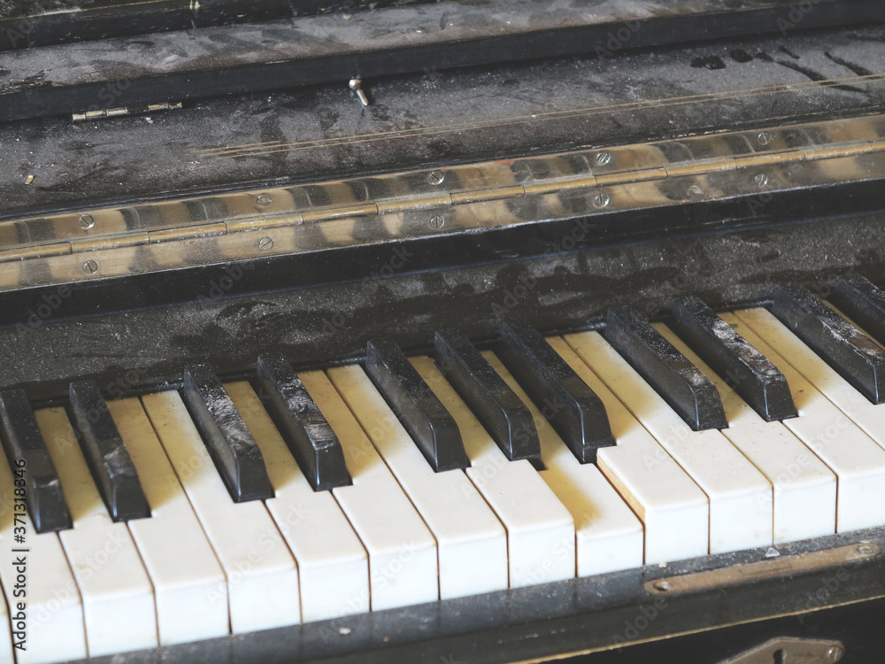 Piano keyboard broken old piano covered with dust and dirt in the interior of an abandoned ruined concert hall, a cinema. Piano keyboard broken old piano covered with dust and dirt in the interior of an abandoned ruined concert hall, a cinema.