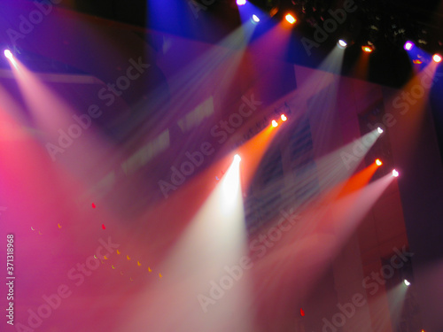 multicolored spot lights in a theater creating an abstract scene