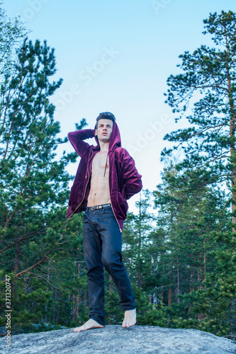 young attractive guy in woods alone practicing sport activity, lifestyle people concept © iordani