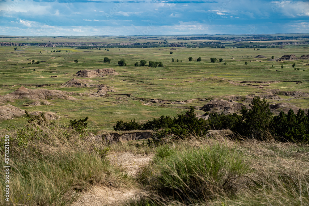 Distant view of badlands rock formations and praire plains of Badlands National Park in South Dakota