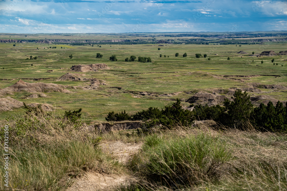 Distant view of badlands rock formations and praire plains of Badlands National Park in South Dakota Distant view of badlands rock formations and praire plains of Badlands National Park in South Dakota
