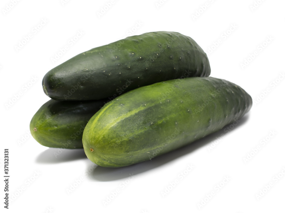 Three whole cucumbers stacked on top of each other Three whole cucumbers stacked on top of each other