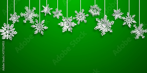 Christmas background with volume paper snowflakes with soft shadows on green background