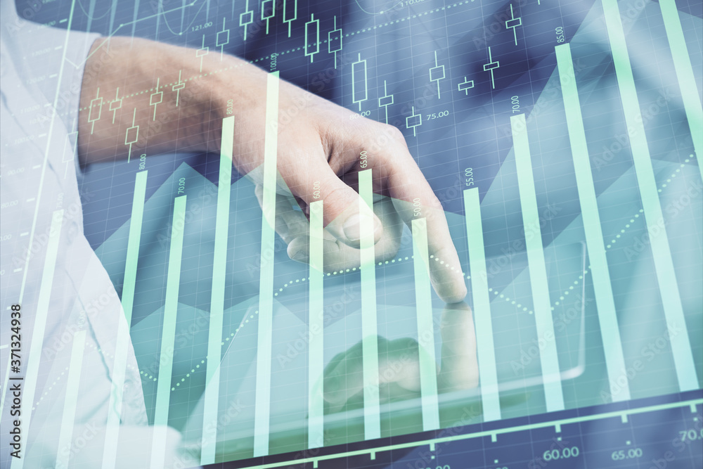Double exposure of man's hands holding and using a digital device and forex graph drawing. Financial market concept. Double exposure of man's hands holding and using a digital device and forex graph drawing. Financial market concept.